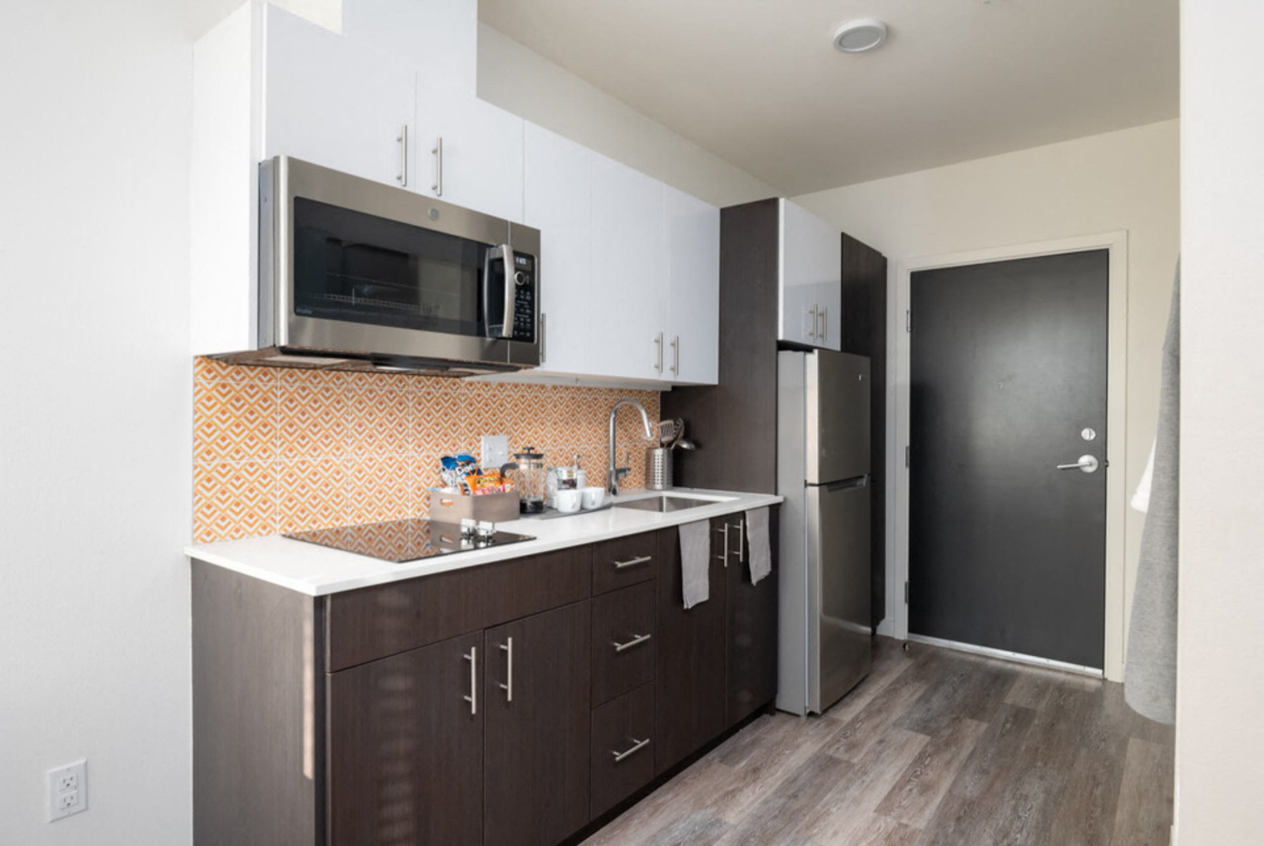 a kitchen with a sink and a microwave and a refrigerator at Enve, Washington, 98102